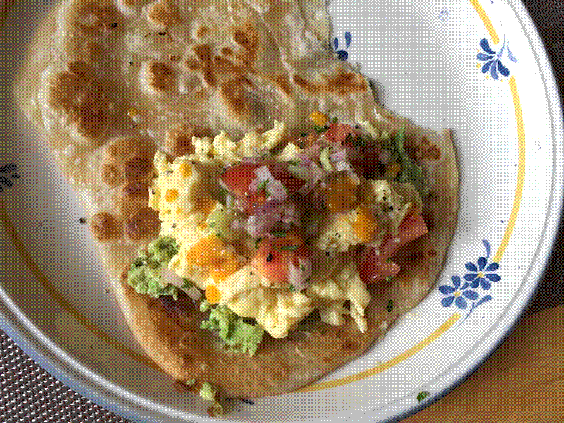 South-western style breakfast eggs with salsa, hot sauce and avocado